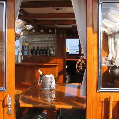 A look inside the Barbarella with an onboard bar and a bottle of champagne on the table